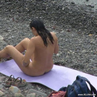 Naked babe tanning in front of a couple
