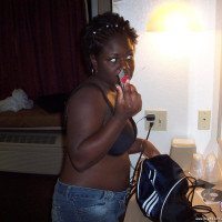 Chubby black babe licking her big boobs