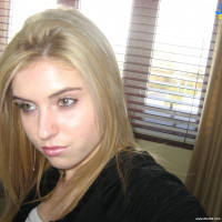 Blonde babe goes for some topless pose