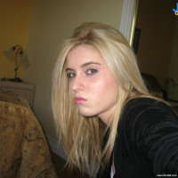 Blonde babe goes for some topless pose