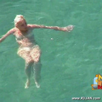 Cute naked blonde enjoys the cold water
