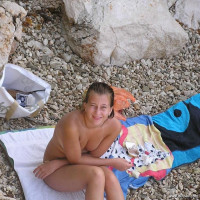 Young nudist couple posing outdoors