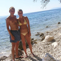 Young nudist couple posing outdoors