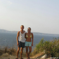 Young nudist couple posing outdoors