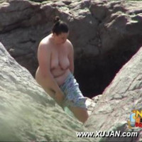Chubby dark hair Latina walking naked on a public beach