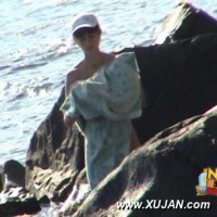 Beautiful naked couple filmed while acting naughty at the beach