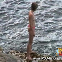 Brunette in a pink bikini is ready for a swim