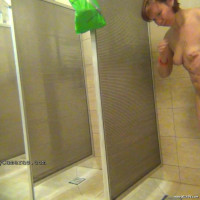 Washing her naked body and puting on a bikini