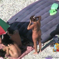 Threesome under the umbrella with two fine girls