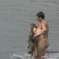 Fat amateur lady with massive tits taking a swim