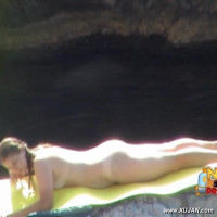Gorgeous brunette is trying to get a suntan