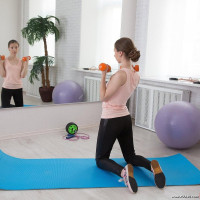 Trainer makes cutie work out by fingering her tight asshole