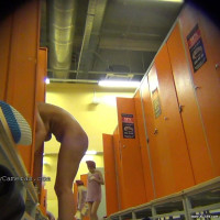 Slutty cougar checking her phone naked in the dressing room