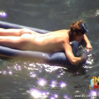 Mature brunette takes a long relaxing swim naked