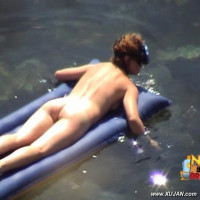 Mature brunette takes a long relaxing swim naked