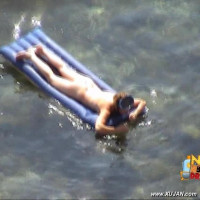 Mature brunette takes a long relaxing swim naked