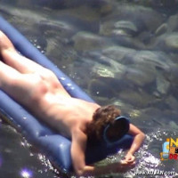 Mature brunette takes a long relaxing swim naked