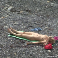 Slim naked girl caught on camera while tanning