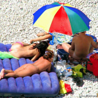 Mature blonde sitting topless in the shade