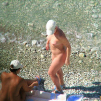 Beautiful blonde gets naked out of the water