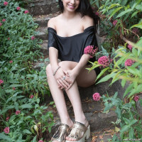 Ornella strips outdoors with a sexy rose in hand