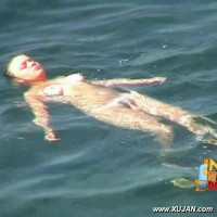 Kinky dark hair model has fun in the water