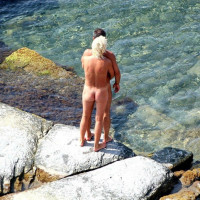 Totally naked couples enjoy sex on the beach