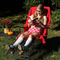 Kinky nerd Hannah Hays works a massive dildo into her twat in the yard