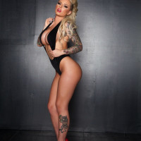 Alluring slut Christy Mack flaunts round big tits stunning tattoos in heels