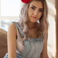 Young blonde Eva Elfie shows off her great body with a flower in her hair