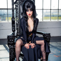 Dark haired female Larkin Love exposes her big boobs in fetish attire