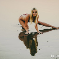 Blonde chick Kenna James models on a beach before an intense fuck indoors
