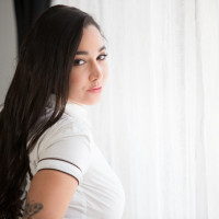 Alluring solo girl Karlee Grey reveals her nice melons as she undresses