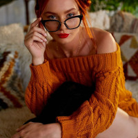 Sexy redhead Lacy Lennon arches her back while naked in black OTK socks
