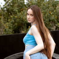 Tall young girl Hazel Moore gets completely naked in a backyard location