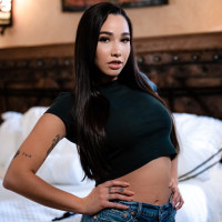 Lena Paul uncovers her big tits on a bed while Karlee Grey exposes a black bra