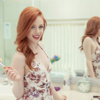 Sexy redhead Ella Hughes licks her fingers after they were inside her vagina