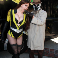 Busty Maitland Ward wearing latex bodysuit fishnets and boots at the Long Beach