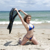 Beach babe Lena Paul freeing nice melons from bikini by swimming pool