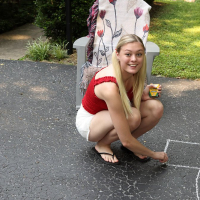 Solo babe Amber Moore having fun with some toys outdoors