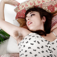 Aged brunette female Simone Delilah showing off hairy pits and legs