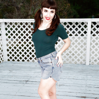Older all natural model Simone Delilah revealing beaver on patio in pigtails