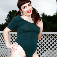 Older all natural model Simone Delilah revealing beaver on patio in pigtails