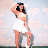 Naughty chick Jane Wilde stripping naked on a golf court