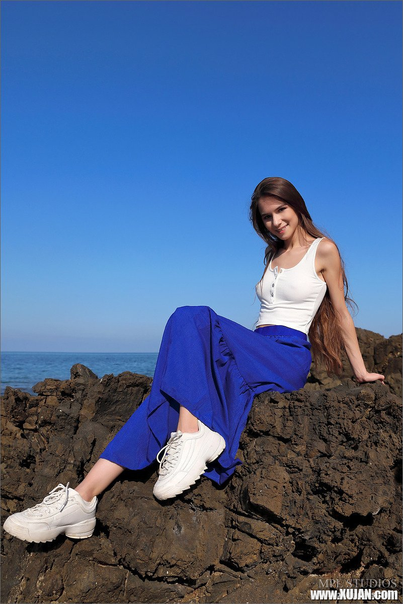 Petite Leona Mia gets naked on the rocky beach - Photo #507725