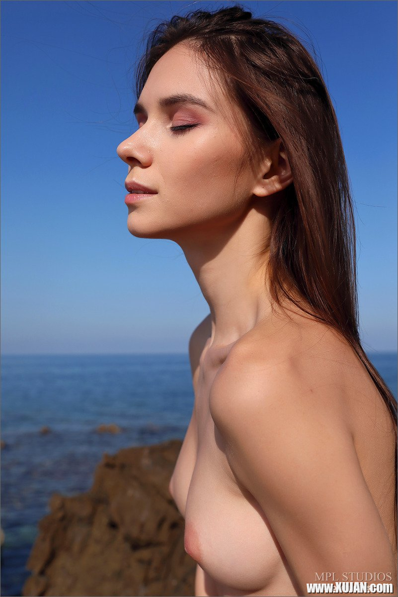 Petite Leona Mia gets naked on the rocky beach - Photo #507734
