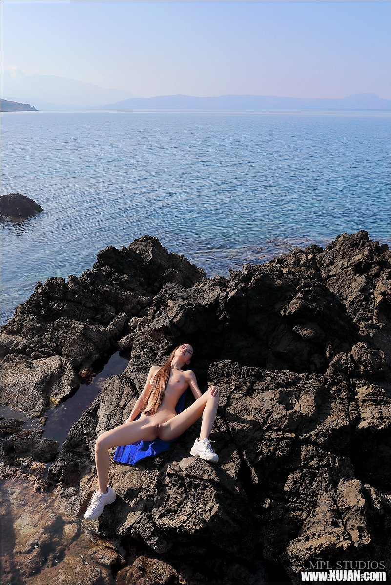 Petite Leona Mia gets naked on the rocky beach - Photo #507736