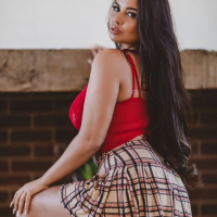 Brunette chick Kym Graham puts her big round tits on display