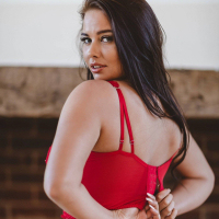 Brunette chick Kym Graham puts her big round tits on display