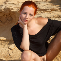 Ariel Piper Fawn swings red hair around while stripping for nude glam shoot